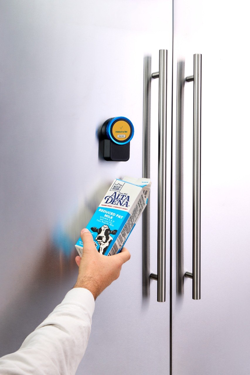 Milk held up to the Trepo device, which has added it to the shopping list and is offering to buy it